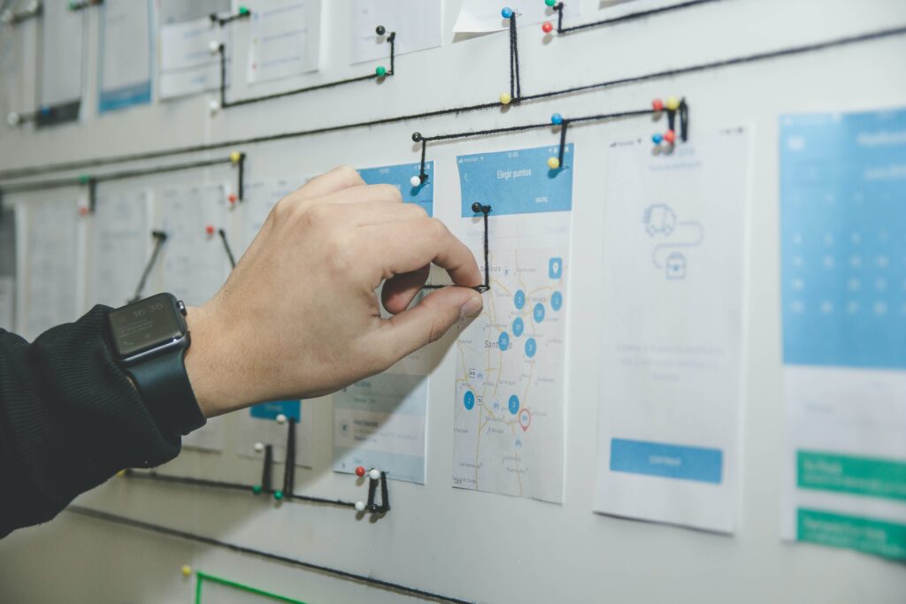 a hand touching a map on a white board