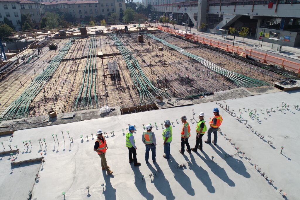 a group of men standing on a concrete surface